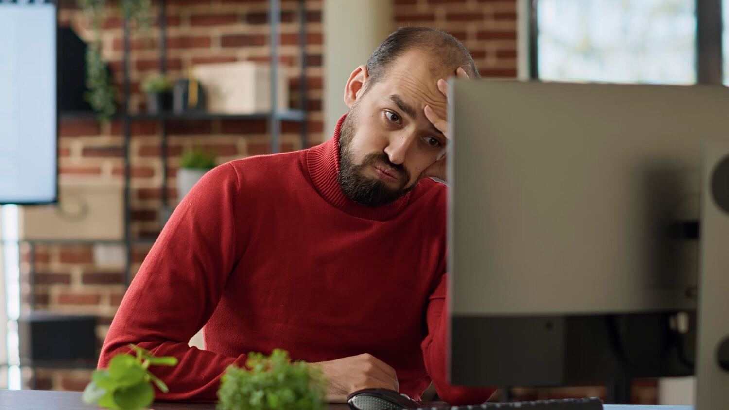 Man looking worried at his laptop